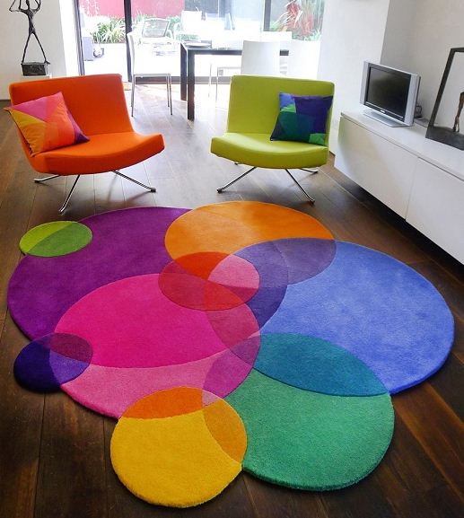 Интересное сочетание ярких кресел с разноцветными круглыми ковриками разного размера